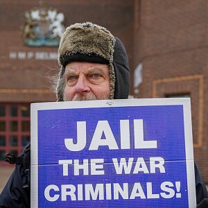 Protester_outside_Belmarsh_Prison_with_placard_'Jail_the_War_Criminals_!'